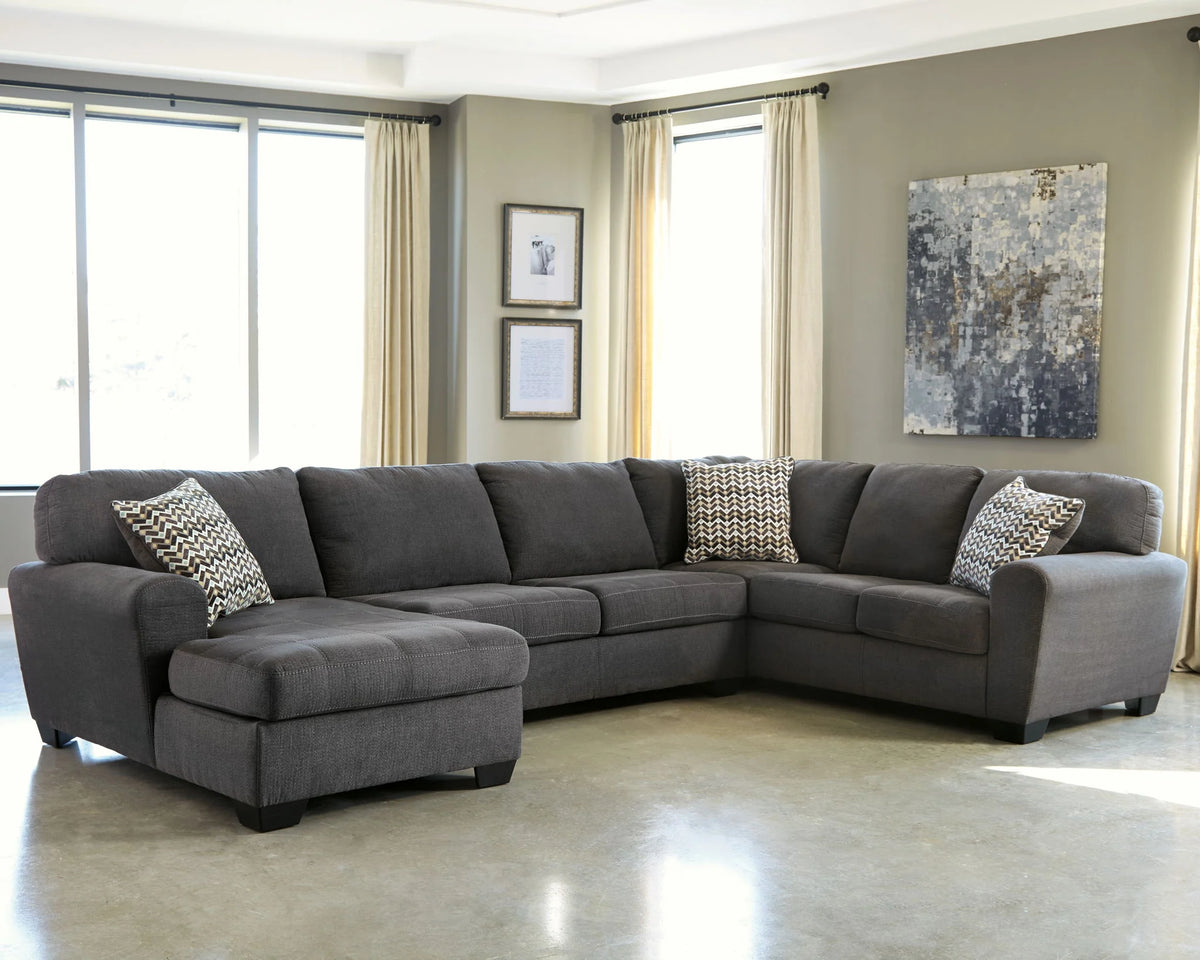 Ambee slate gray sectional with a chaise and geometric accent pillows in a living room