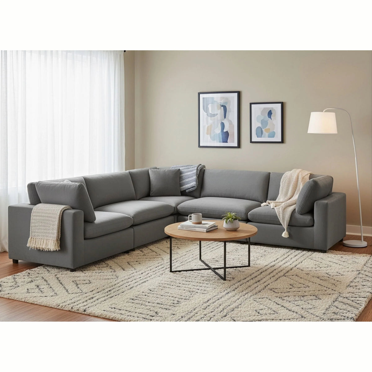 Caylie charcoal L-shaped sectional with loose back cushions in a living room