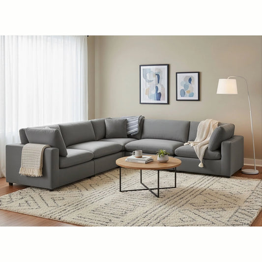 Caylie charcoal L-shaped sectional with loose back cushions in a living room