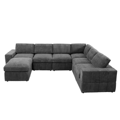 Dark gray modular corner sectional with an ottoman chaise on a white background
