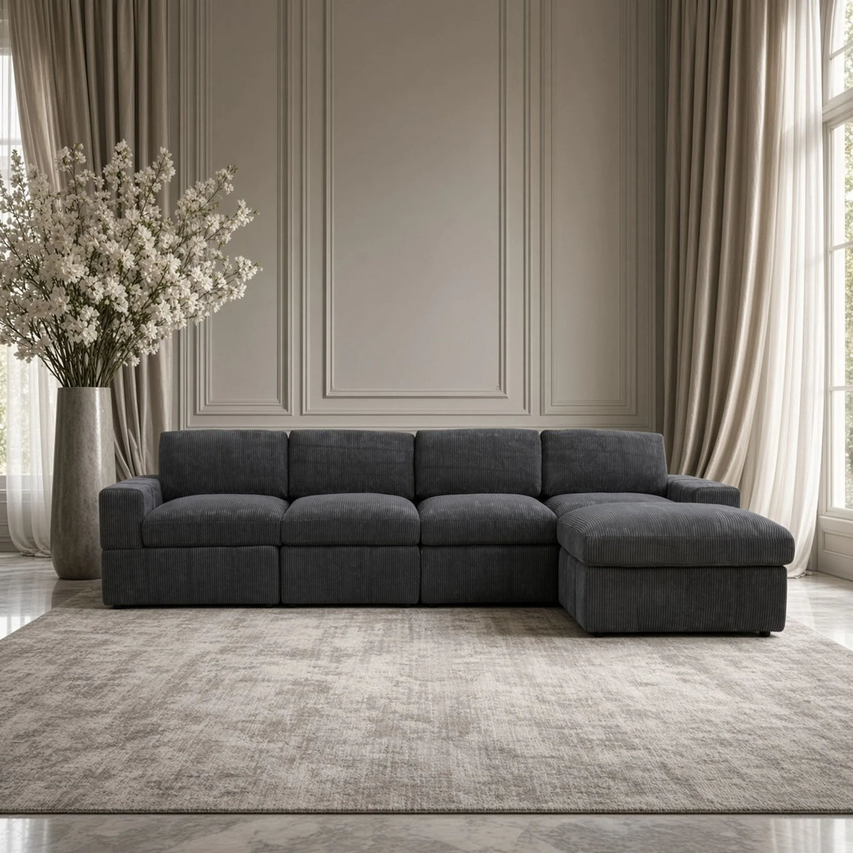 Front view of a dark gray modular sofa with one ottoman in a living room