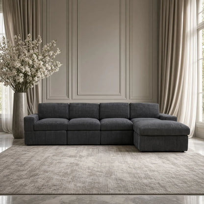 Front view of a dark gray modular sofa with one ottoman in a living room