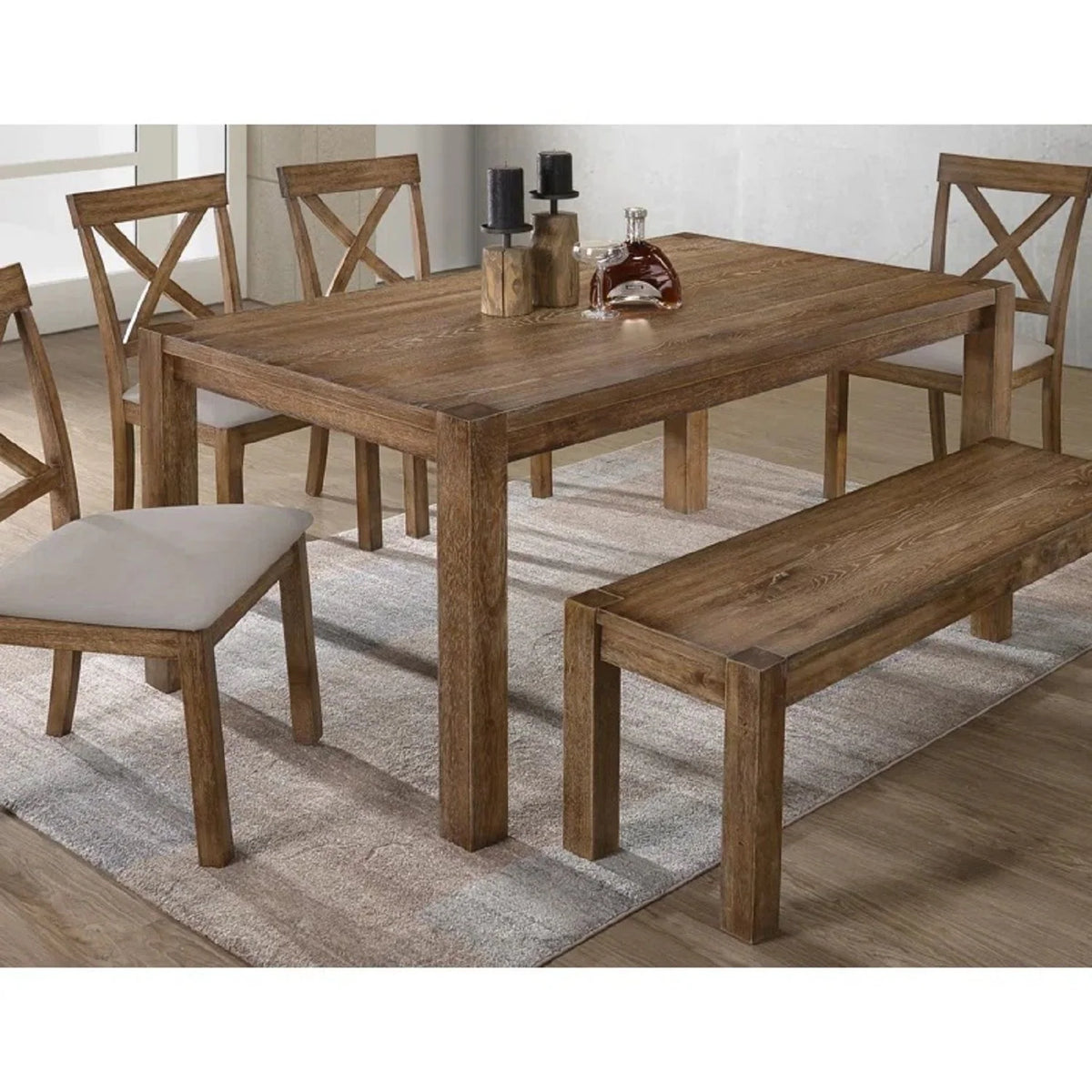 Close view of the antique oak dining tabletop, bench and cushioned X-back chairs