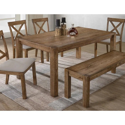Close view of the antique oak dining tabletop, bench and cushioned X-back chairs