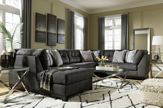 Reidshire steel gray chaise sectional styled with a throw blanket and glass coffee table